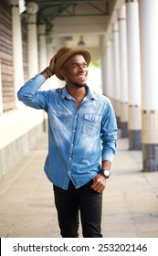 Portrait Of A Happy Young African American Man Walking With Hat