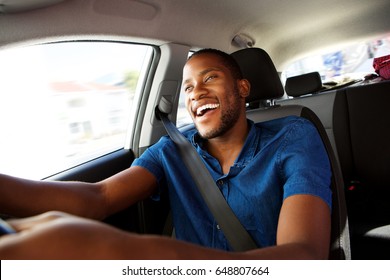 Portrait Of Happy Young African Man Enjoying Driving A Car