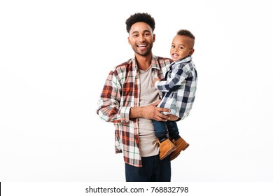 Portrait Of A Happy Young African Man Holding His Little Son While Standing And Laughing Isolated Over White Background