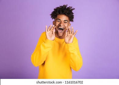Portrait of a happy young afro american man dressed in sweatshirt shouting isolated - Shutterstock ID 1161016702