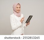 Portrait happy young asian business muslim woman holding tablet smartphone standing on isolated white background. Business Attractive Muslim woman wearing abaya and hijab  costume