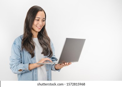 Portrait Of Happy Young Asian Girl Using Laptop Computer Isolated Over White Background