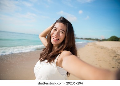 A Portrait Of A Happy Young Asian Woman Take Photos Of Her Self, Smile To Camera