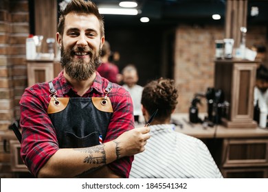 Portrait of happy young barber with client at barbershop and smiling. - Powered by Shutterstock