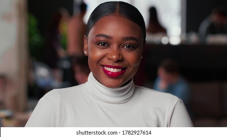Portrait of happy young beautiful 20s gen-z black business woman with red lips smiling at camera at light trendy office. - Shutterstock ID 1782927614