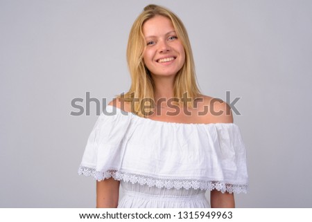 Portrait of happy young beautiful woman with blond hair smiling