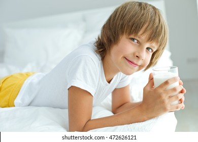 Portrait Of Happy Young Boy Holding Glass Of Milk