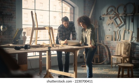 Portrait of Happy Young Business Couple Using Laptop Computer in Designer Furniture Studio. Carpenter and Designer Have Fun, DIscussing and Talking About Upcoming Orders of Wooden Furniture. - Powered by Shutterstock