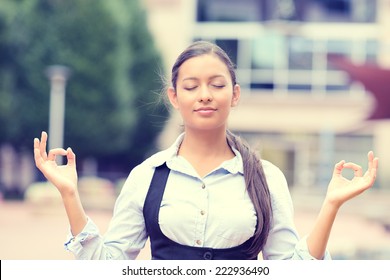 Portrait Happy Young Business Woman In Blue Shirt Eyes Closed Hands Raised In Air Relaxing Meditating Taking Deep Breath Isolated Outside City Background. Corporate Life Style. Stress Relief Technique