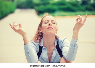 Portrait Happy Young Business Woman In Blue Shirt Eyes Closed Hands Raised In Air Relaxing Meditating Sitting Outside Corporate Office. City Life Style. Stress Relief Technique, Positive Emotions 