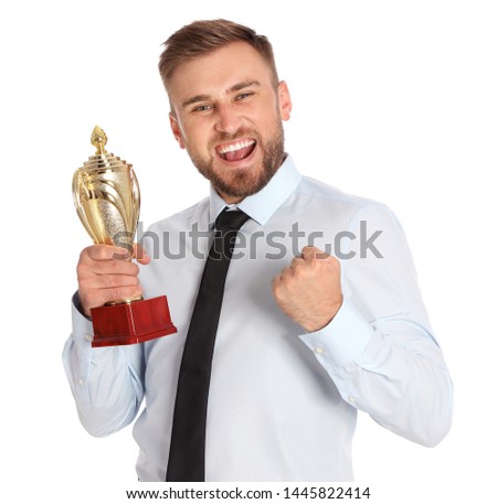 Portrait of happy young businessman with gold trophy cup on white background