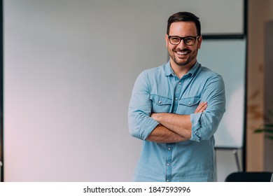 Portrait of happy young businessman at his office - Shutterstock ID 1847593996