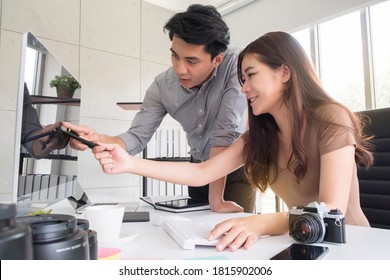 Portrait Of Happy Young Couple Asian Man And Woman Graphic Designer Team Discussing On Projects While Working Together In The Modern Creative Office. Business Creative People, Teamwork Concept.