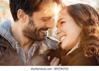 Portrait of happy young couple looking at each other and smiling outdoor