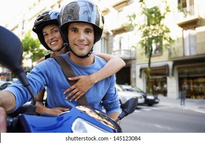 Portrait of happy young couple on scooter enjoying road trip - Powered by Shutterstock