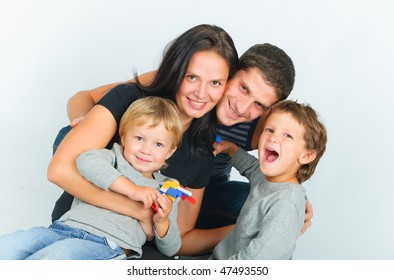 Portrait Of Happy Young Family With Two Sons