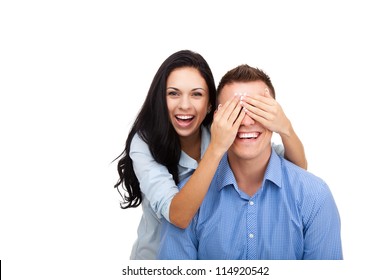 Portrait Of A Happy Young Female Surprise Husband Cover His Eyes, Pretty Woman Covering Mans Eyes, Couple Love Excited Smile, Isolated Over White Background