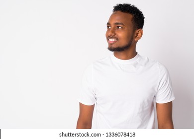 Portrait of happy young handsome African man thinking - Shutterstock ID 1336078418