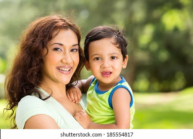 Portrait Of Happy Young Indian Mother And Baby Boy Outdoors