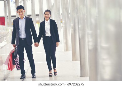 Portrait Of Happy Young Lovely Couple Holding Shopping Bags. Concept Of Consumerism, Sale, Rich Life.