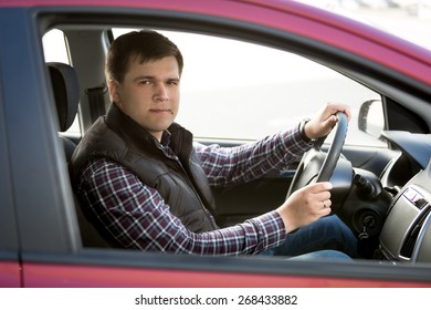 Portrait Of Happy Young Man Driving Small Car