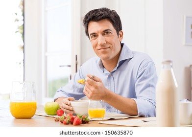 Portrait Of Happy Young Man Having Healthy Breakfast