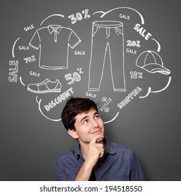 Portrait Of Happy Young Man Looking Up Thinking Of Buying Something