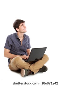Portrait Of Happy Young Man Sitting While Using Laptop Computer On White Background