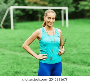 Portrait of a happy young woman coach or instructor posing and smiling outdoors. Athlete and fitness and healhty living concept - Powered by Shutterstock