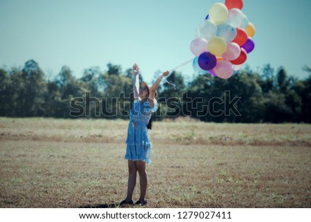 Portrait of a Happy young woman with colorful latex balloons, outdoor