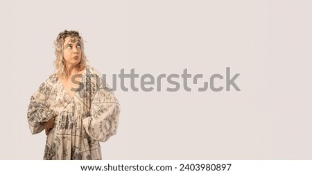 Portrait of a happy young woman dancing isolated on a white background with a tiara on her head wearing a dress