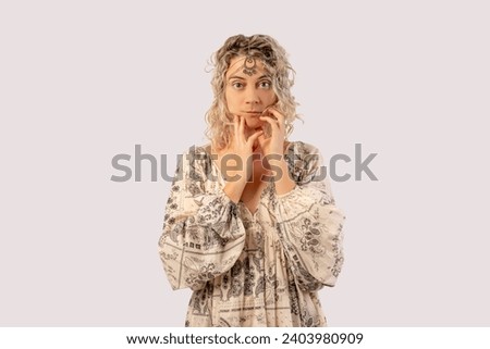 Portrait of a happy young woman dancing isolated on a white background with a tiara on her head wearing a dress