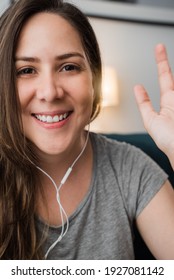 Portrait Of Happy Young Woman Doing Video Call With Mobile Phone At Home During Lockdown Isolation - Focus On Face