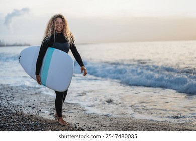 Portrait of happy young woman, girl with surfboard, smiling and enjoying holiday and water sports - Powered by Shutterstock