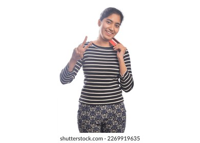 Portrait of happy young woman holding credit card showing victory sign