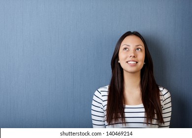portrait of a happy young woman looking up