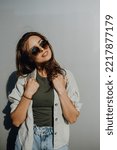Portrait of happy young woman outdoor with backpack and sunglasses.