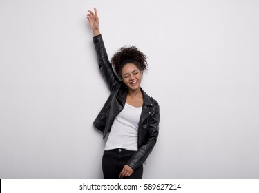 Portrait Of Happy Young Woman With Raising A Hand, Eyes Closed