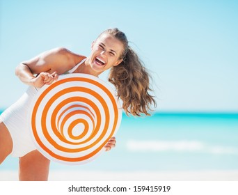 Portrait Of Happy Young Woman In Swimsuit With Beach Hat Having Fun Time On Beach