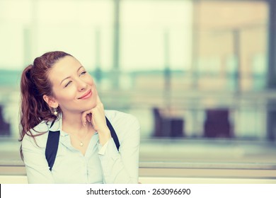 Portrait Happy Young Woman Thinking Dreaming Has Many Ideas Looking Up Isolated Office Windows Background. Positive Human Face Expression Emotion Feeling Reaction. Decision Making Process Concept