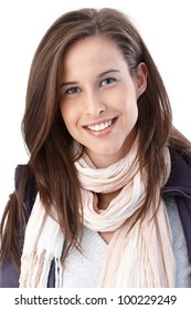 Portrait of happy young woman wearing trendy scarf and casual jacket smiling at camera.