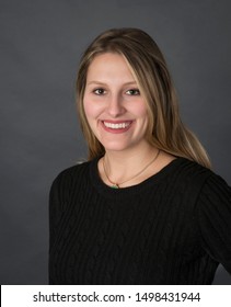 Portrait Head Shot Of Beautiful Twenty Something Professional Woman In Black Sweater