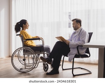 Portrait health care latin american woman sick sit wheelchair with man doctor caucasian two people check and treat patients talk help support explain medicine sick person inside hospital clinic room  - Powered by Shutterstock