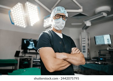 Portrait, healthcare and arms crossed by man doctor in operating room with confidence in medical, surgery or emergency. Hospital, face mask and male surgeon in theatre with pride, help or leadership - Powered by Shutterstock