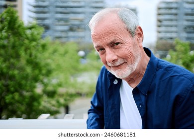 Portrait of a Healthy Happy Caucasian Senior Man with Gray Hair Standing Outside in Front of a Garden Area at Nursing Home. Old Adult Grandfather Posing and Looking at Camera and Smiling. Copy Space - Powered by Shutterstock