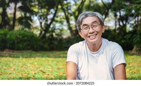 Portrait Of Healthy Happy Senior Asian Old Man In The Park Outdoors Exercise Stretching His Arms. Spring Healthcare Lifestyle Grandfather Retirement Wellness Healthy, Chinese Old Men Concept 