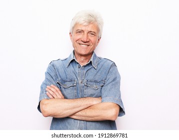Portrait of healthy happy smile senior elderly caucasian old man face with arm crossed isolated on white. Golden age grand father healthcare cheerful lifestyle, freedom relax retirement concept