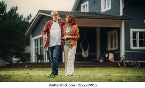 Portrait of a Healthy Senior Couple Walking Outdoors Their Residential Area Home, Embracing Each Other. Loving Adults, Talk, Have Fun, Point to the Distance and Enjoy Their Happy Retirement Life. - Powered by Shutterstock