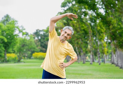 portrait healthy senior man with grey hair fitness stretching before workout in the park, older adult warming up exercise among the nature, concept elderly people health care, wellness, wellbeing - Shutterstock ID 2299962953