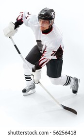 Portrait of healthy sportsman playing hockey on ice